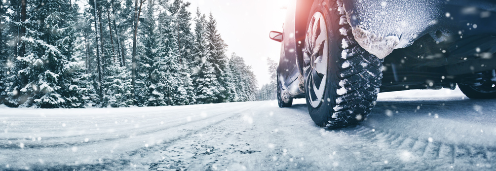 Closeup of car tires in winter on the road - Farm Bureau Insurance